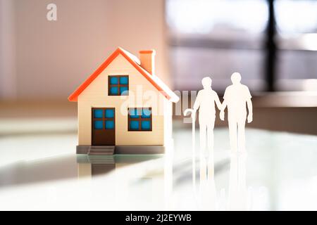 Senior Couple Standing Together Outside Their New House Stock Photo