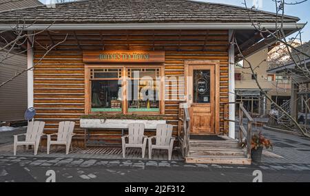 Banff, Alberta, Canada – March 30, 2022:  Exterior view of “Jolene’s Tea House” in a historic downtown log building Stock Photo