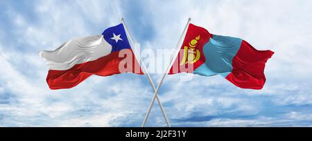 crossed national flags of Chile and Mongolia flag waving in wind at ...