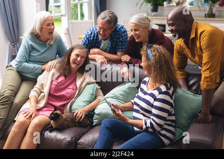 Cheerful multiracial senior male and female friends having fun at home Stock Photo