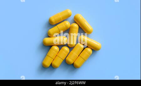 Yellow medicine pills on a blue background Stock Photo
