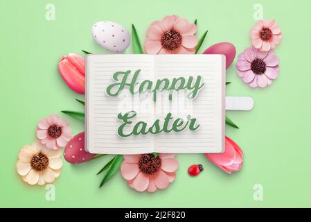 Happy Easter greeting card with notebook and Easter eggs and flowers Stock Photo