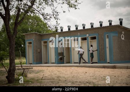 Students make use of new bathroom toilets - outdoor pit latrines - at a public primary school in  Oshana Region, Namibia, southern Africa. Stock Photo