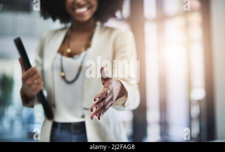 Welcome to the team, Ill show you around the office. Shot of an unrecognizable businesswoman reaching out for a handshake. Stock Photo