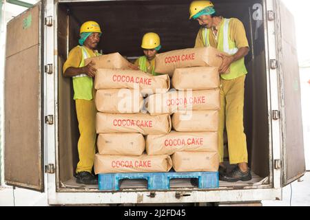 Workers unloading cocoa cake Mars Chocolate Indonesia warehouse in West Sulawesi, Indonesia, Asia. Stock Photo