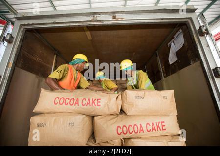Workers unloading cocoa cake Mars Chocolate Indonesia warehouse in West Sulawesi, Indonesia, Asia. Stock Photo