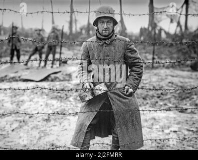 WWI German prisoner of war behind barbed wire of POW camp at Langemarck, West Flanders, Belgium in 1917 during First World War One Stock Photo