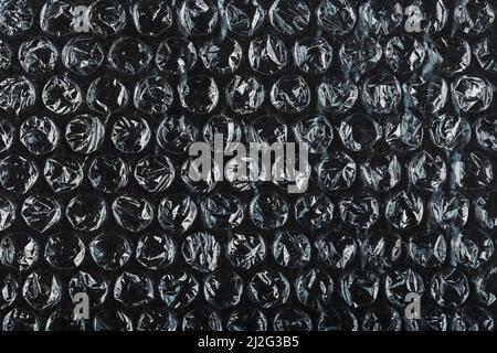 Packing bubble wrap for parcels on a Black background in full screen Stock Photo