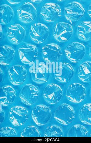 Packing bubble wrap for parcels on a blue background in full screen Stock Photo