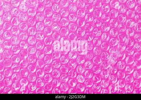 The texture of the packaging air-bubble film on a Pink background in full screen Stock Photo