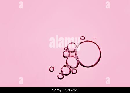 oil with bubbles on pink background. Abstract space background. Soft selective focus. macro of oil drops on water surface. copy space. air bubbles in Stock Photo
