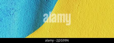 Banner made from the National Yellow and Blue Flag of Ukraine painted on beautiful textured concrete wall. The art of rough stylized texture. Copy spa Stock Photo