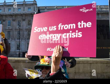 London, UK 31st January 2022. A protester holds a placard which reads 'Save us from the energy crisis' Charity organisation Age UK were joined by supporters outside Downing Street as they delivered a letter to Boris Johnson signed by over 97700 people, urging the government to help elderly people with their energy bills. One million older people live in fuel poverty and are unable to afford the cost of heating during winter. Stock Photo