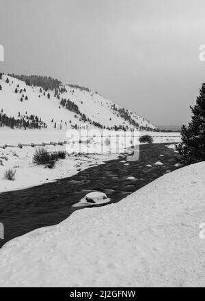 River runs through snow in the Sawtooth National Recreation Area, Stanley, Idaho Stock Photo