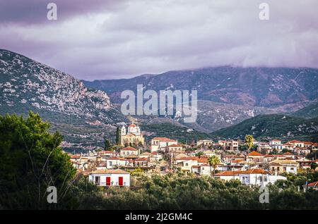 View down in valley at tile roofs of Greek village with large church in Taygetos Mountains between Kardamyli and Kalamata on Peloponnese Peninsula wit Stock Photo