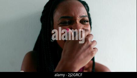 African woman laughing spontaneously, real life authentic laugh and smile Stock Photo
