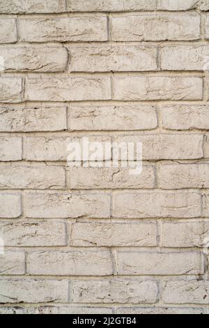 A vertical shot of an old white brick wall Stock Photo