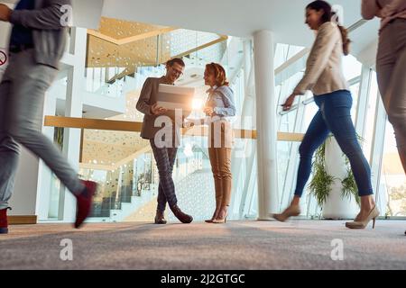 Pleasant atmosphere in a busy hallway with employees in the company's building. Business, people, company Stock Photo
