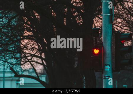 Red heart-shaped traffic light as a sign of hope and love in Sofia, Bulgaria on St. Valentines Day. Love, romantic, couples day. High quality photo Stock Photo