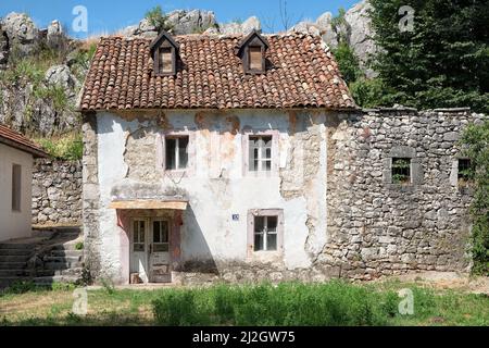 NIKSIC, MONTENEGRO - JULY 17, 2017: windows garret on abandoned traditional house in Niksic, Montenegro Stock Photo