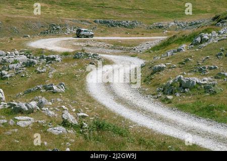 LUKAVICA, MONTENEGRO - JULY 18, 2017: off road car on a curvy and rough road of Montenegro Mountain Stock Photo