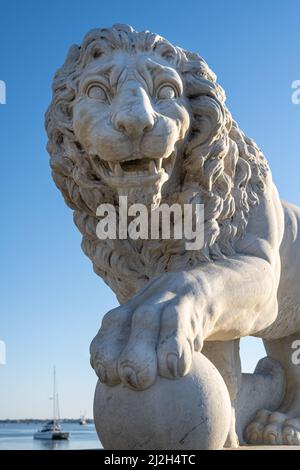 White Carrara marble lion statue at the Bridge of Lions on the Matanzas Bay waterfront in historic Old City St. Augustine, Florida. (USA) Stock Photo