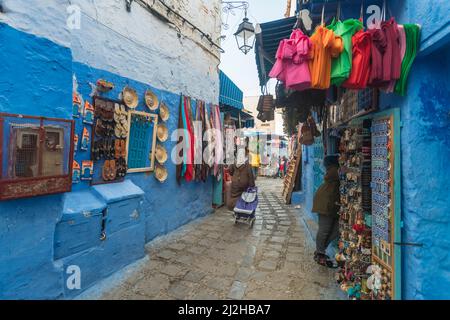 Morocco, Chefchaouen, Narrow alley and souvenirs for sale at traditional houses Stock Photo