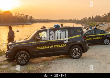 IRS tax evasion police guardia di finanza at sunset in the coast of river Po, Lombardy, Italy Stock Photo