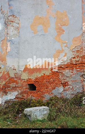 Old brick wall with remnants of plaster Stock Photo