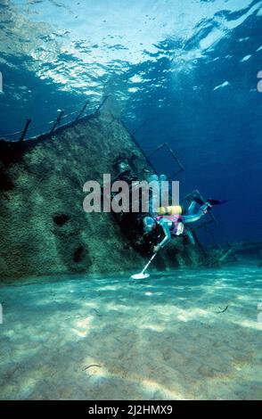 Scuba diver searching with a metal dedector at a sunken shipwreck, Ponza island, Italy Stock Photo