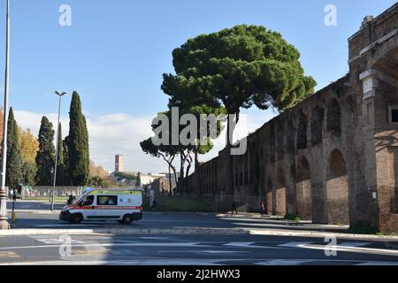 A contrast between modern and ancient times. An ambulance passes through the Aurelian Walls built between 27 and 275 AD. Rome, Italy, November 24, 201 Stock Photo