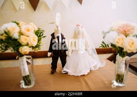 Wedding concept. Bride and fiance. Figurines of the bride and groom with faces of rabbits Stock Photo