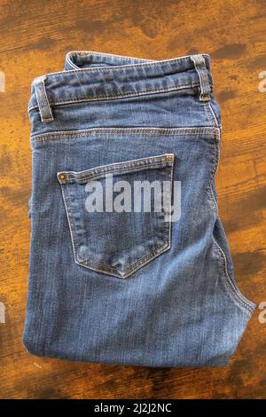 blue jeans isolated on a wooden background Stock Photo