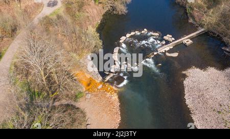 Aerial view of orange iron oxide staining in stream entering River Neath at Abergarwed. The source is water discharging from an abandoned coal mine. Stock Photo