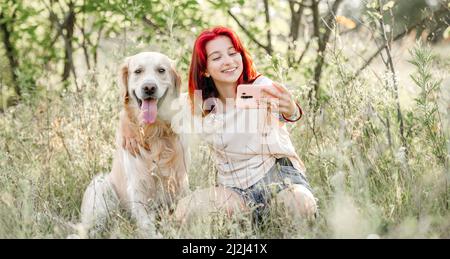 Teen girl with golden retriever dog Stock Photo