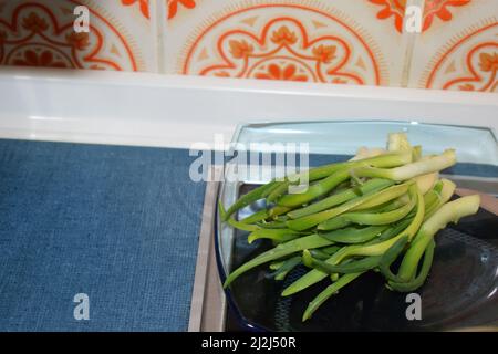 onion sprouts on a blue glass plate Stock Photo