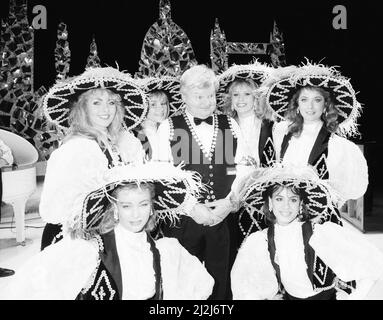 Benny Hill, British comedian and actor, best known for his television programme The Benny Hill Show, in America, where he is filming a one hour special, Benny Hill's World Tour : New York, which will be shot on location in New York City, Saturday 28th March 1987. Our Picture Shows ... Benny Hill photocall with Hill's Angels. Stock Photo