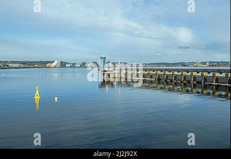 The view across Cardiff Bay from the Cardiff Bay Barrage walk on a sunny April morning Stock Photo