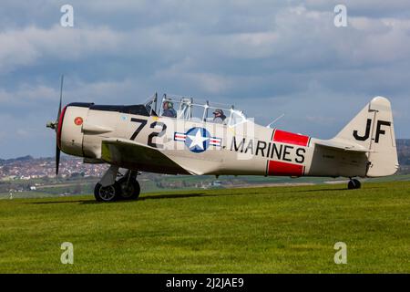 Compton Abbas, Dorset UK. 2nd April 2022. UK weather: light aircraft , including some vintage, take to the skies on a sunny, but chilly day at Compton Abbas Airfield in Dorset. Harvard Warbird.  Credit: Carolyn Jenkins/Alamy Live News Stock Photo