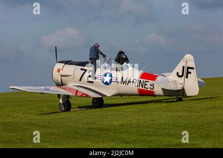 Compton Abbas, Dorset UK. 2nd April 2022. UK weather: light aircraft , including some vintage, take to the skies on a sunny, but chilly day at Compton Abbas Airfield in Dorset. Harvard Warbird. Credit: Carolyn Jenkins/Alamy Live News Stock Photo