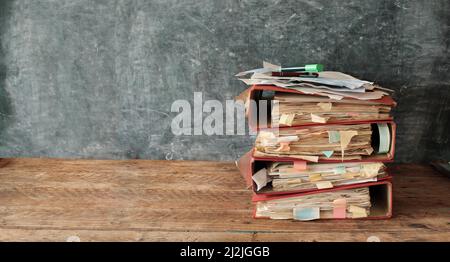 Heap of messy file folders,red tape, bureaucracy,aministration,business concept. Large free copy space, negative  space technique Stock Photo