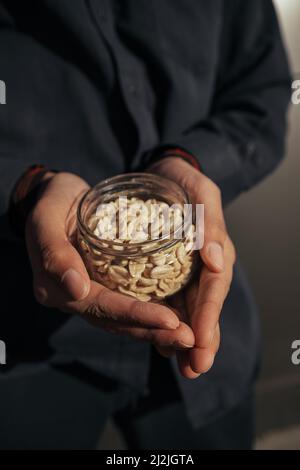 Different types of nuts, nut of peanuts in hands. Stock Photo