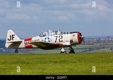 Compton Abbas, Dorset UK. 2nd April 2022. UK weather: light aircraft , including some vintage, take to the skies on a sunny, but chilly day at Compton Abbas Airfield in Dorset. Harvard Warbird. Credit: Carolyn Jenkins/Alamy Live News Stock Photo