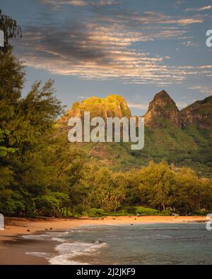 The Kalalea Mountain Ridge rises behind Anohola beach along the east coast of Kauai, Hawaii. Stock Photo