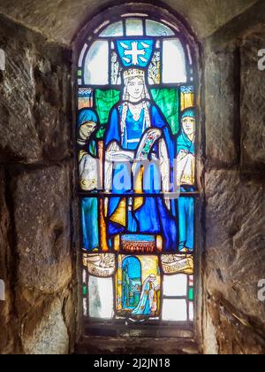 A 1922 stained glass window by Douglas Strachan depicting St. Margaret, Queen of Scotland, in Saint Margaret's Chapel at Edinburgh Castle. Stock Photo