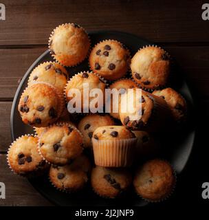 Dark food macro photography, vanilla cupcakes with chocolate chips, concept of homemade desserts. Stock Photo