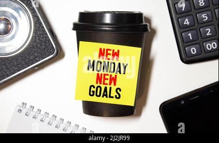 New Monday, new week, new goals - handwriting on a napkin with a cup of coffee. Stock Photo