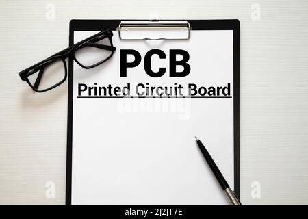PCB Printed Circuit Board, TEXT ON white paper on light background. Stock Photo