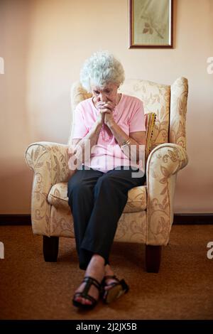 Lord, please help me. Shot an elderly woman looking worried. Stock Photo