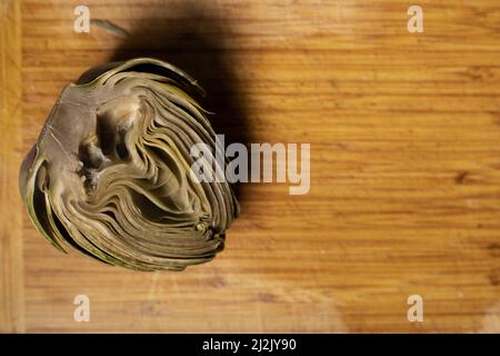 view area artichoke in half on bamboo wood board Stock Photo